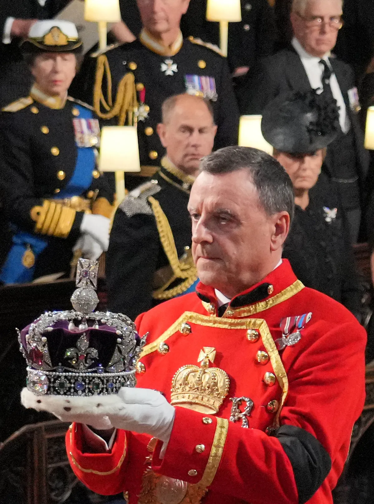 The Imperal State Crown is removed from the coffin by the Crown Jeweller inside St George's Chapel at Windsor Castle at the Committal Service for Britain's Queen Elizabeth II on September 19, 2022. Jonathan Brady / POOL / AFP
