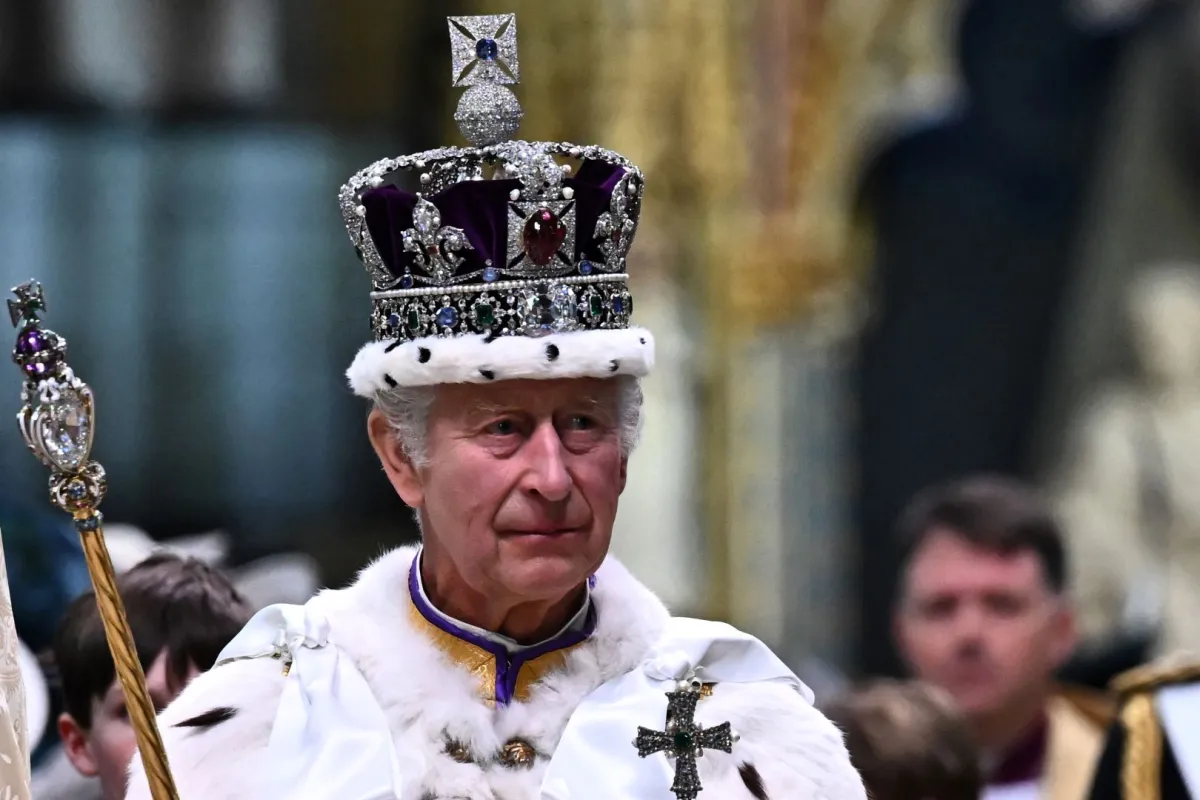 King Charles III wearing the Imperial state Crown carrying the Sovereign's Orb and Sceptre leaves Westminster Abbey after the Coronation Ceremonies in central London on May 6, 2023. Ben Stansall / POOL / AFP
