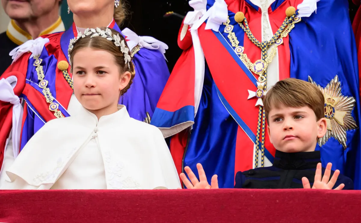 Princess Charlotte of Wales and Britain's Prince Louis of Wales stand on the Buckingham Palace balcony as they wait for the Royal Air Force fly-past in central London on May 6, 2023, after the coronations of King Charles III and Queen Camilla. Leon Neal / POOL / AFP