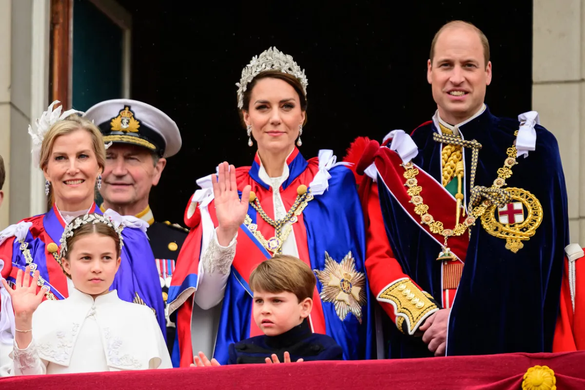 Prince William, Prince of Wales, Britain's Catherine, Princess of Wales, Britain's Princess Charlotte of Wales and Britain's Prince Louis of Wales wave to the crowds from the Buckingham Palace balcony as they wait for the Royal Air Force fly-past in central London on May 6, 2023, after the coronations of King Charles III and Queen Camilla. Leon Neal / POOL / AFP