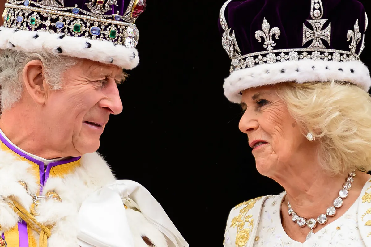 King Charles III (L) looks at Queen Camilla as they stand on the Buckingham Palace balcony, in London, following their coronations, on May 6, 2023.  Leon Neal / POOL / AFP