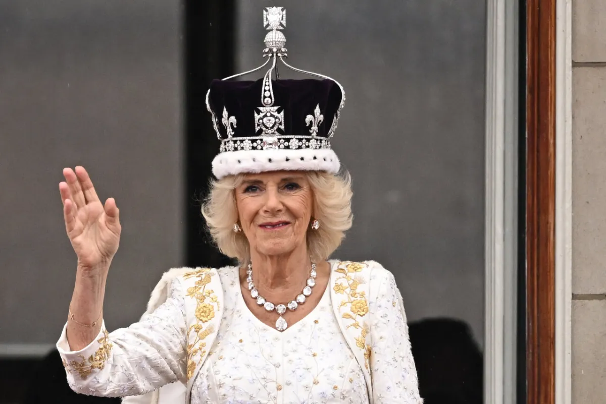 Britain's Queen Camilla wearing a modified version of Queen Mary's Crown waves from the Buckingham Palace balcony after viewing the Royal Air Force fly-past in central London on May 6, 2023, after their coronations.  Oli SCARFF / AFP