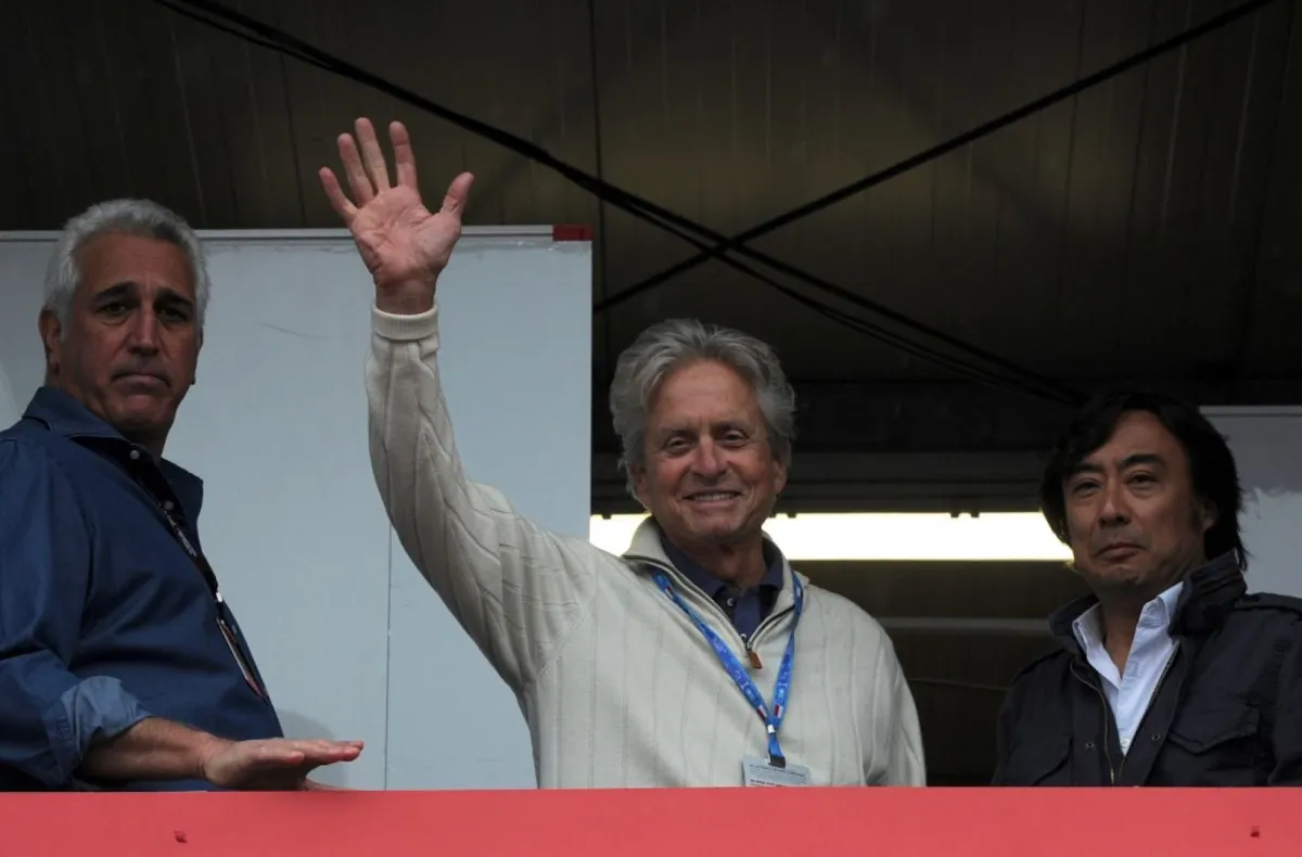 Micheal Douglas waves in Monte Carlo on May 25, 2013. AFP PHOTO / BORIS HORVAT (Photo by BORIS HORVAT / AFP)