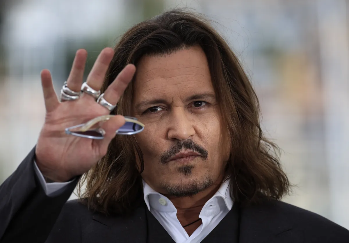 US actor Johnny Depp gestures as he poses during a photocall for the film "Jeanne Du Barry" during the 76th edition of the Cannes Film Festival in Cannes, southern France, on May 17, 2023. (Photo by Valery HACHE / AFP)
