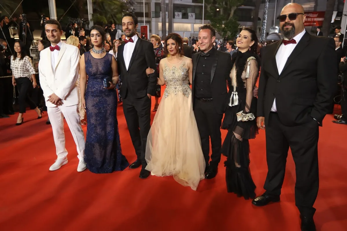  (FromL) French-Tunisian producer Nadim Cheikhrouha, Tunisian director Kaouther Ben Hania (C), Tunisian actress Mariam Al Ferjani (2ndL), Tunisian actor Ghanem Zrelli (3rdL), producer Mohamed Habib Attia (3rdR), French-Tunisian actress Anissa Daoud (2ndR) and Tunisian actor Chedly Arfaoui (R) pose as they arrive on May 19, 2017 for the screening of the film 'Beauty and the Dogs' (Aala Kaf Ifrit) at the 70th edition of the Cannes Film Festival in Cannes, southern France. (Photo by Valery HACHE / AFP)