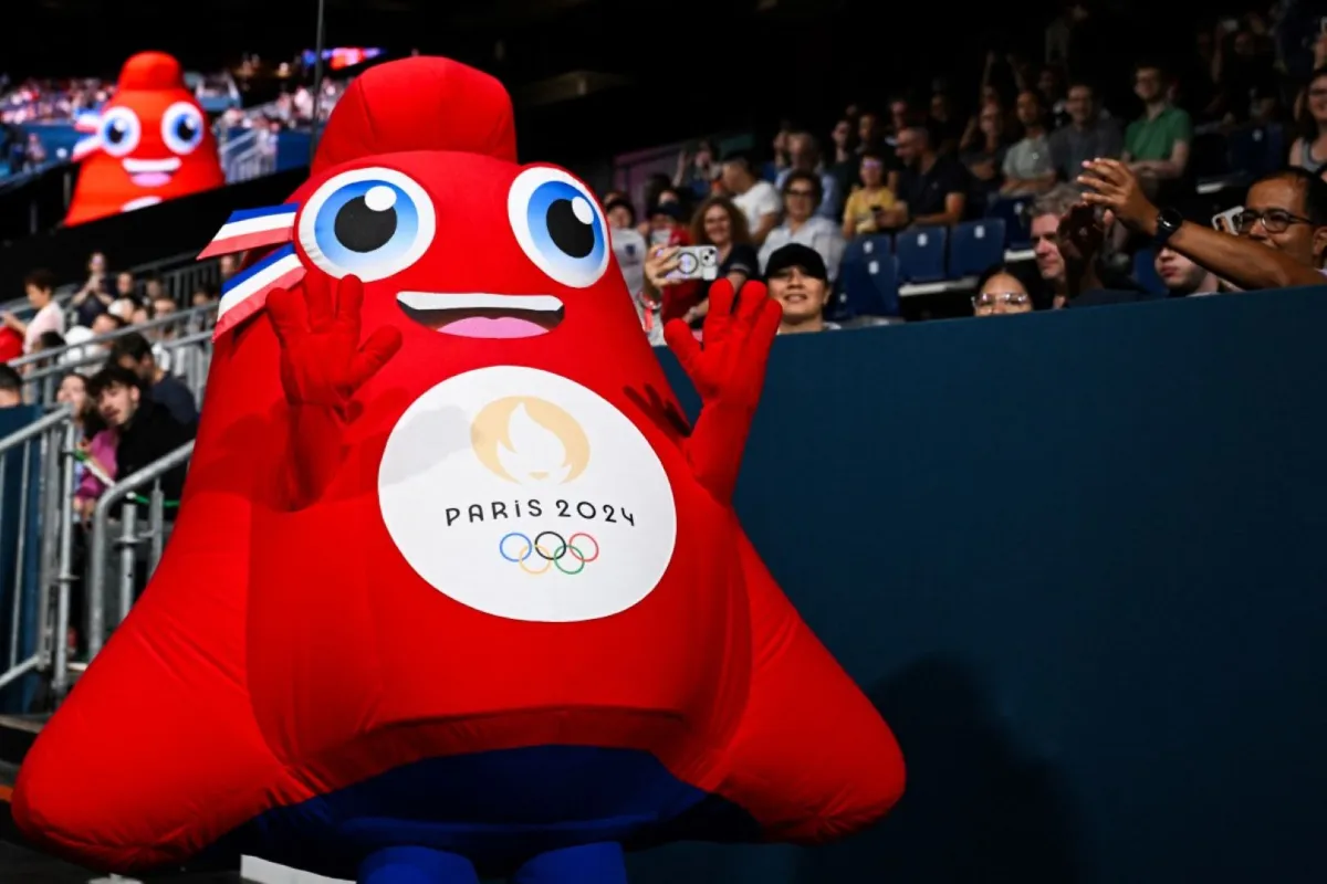Olympic Phryge, the official mascot of the Paris 2024 Olympic Games greets members of the public prior to the start of the men and women's table tennis singles preliminary rounds at the Paris 2024 Olympic Games at the South Paris Arena in Paris on July 27, 2024. (Photo by JUNG Yeon-je / AFP)