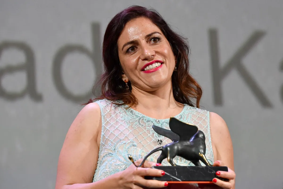 المخرجة سؤدد كعدان بعد حصولها على جائزة ‏Lion of the Future‏ في فينسيا- ‏Director Soudade Kaadan poses ‎after she received the Lion of the Future "Luigi De Laurentiis" Venice Award‏ - مصدر الصورة: ‏‏(‏Photo by Alberto PIZZOLI / AFP‏)‏