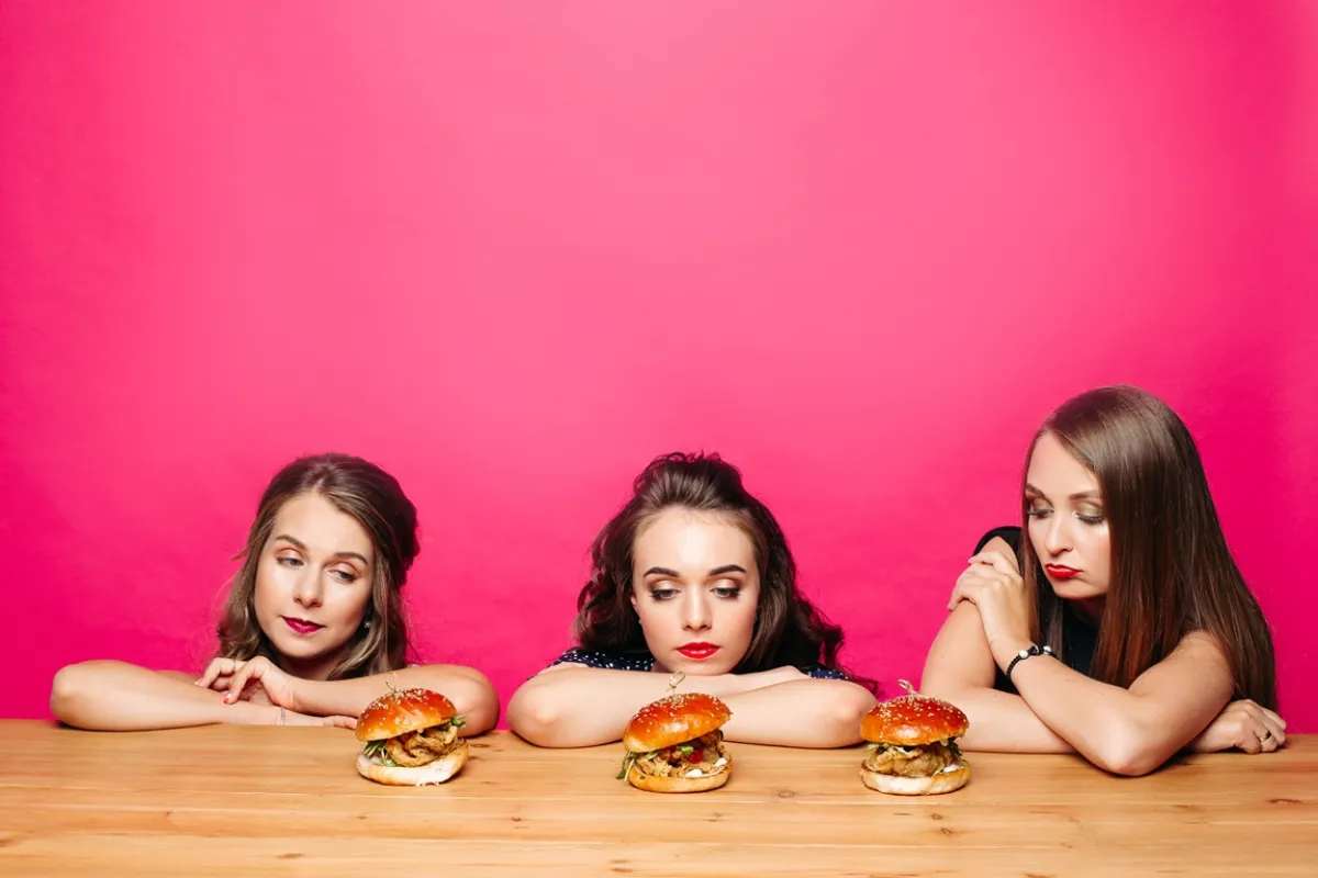 فتيات ينظرن إلى الطعام  Image By Freepik