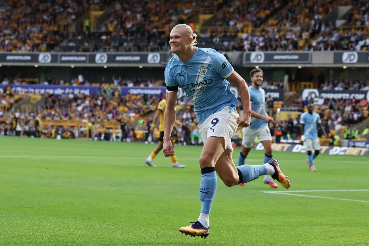 Erling Haaland celebrates scoring their third goal during the English Premier League football match between Wolverhampton Wanderers and Manchester City at the Molineux stadium in Wolverhampton, central England on August 16, 2025. (Photo by Darren Staples / AFP)