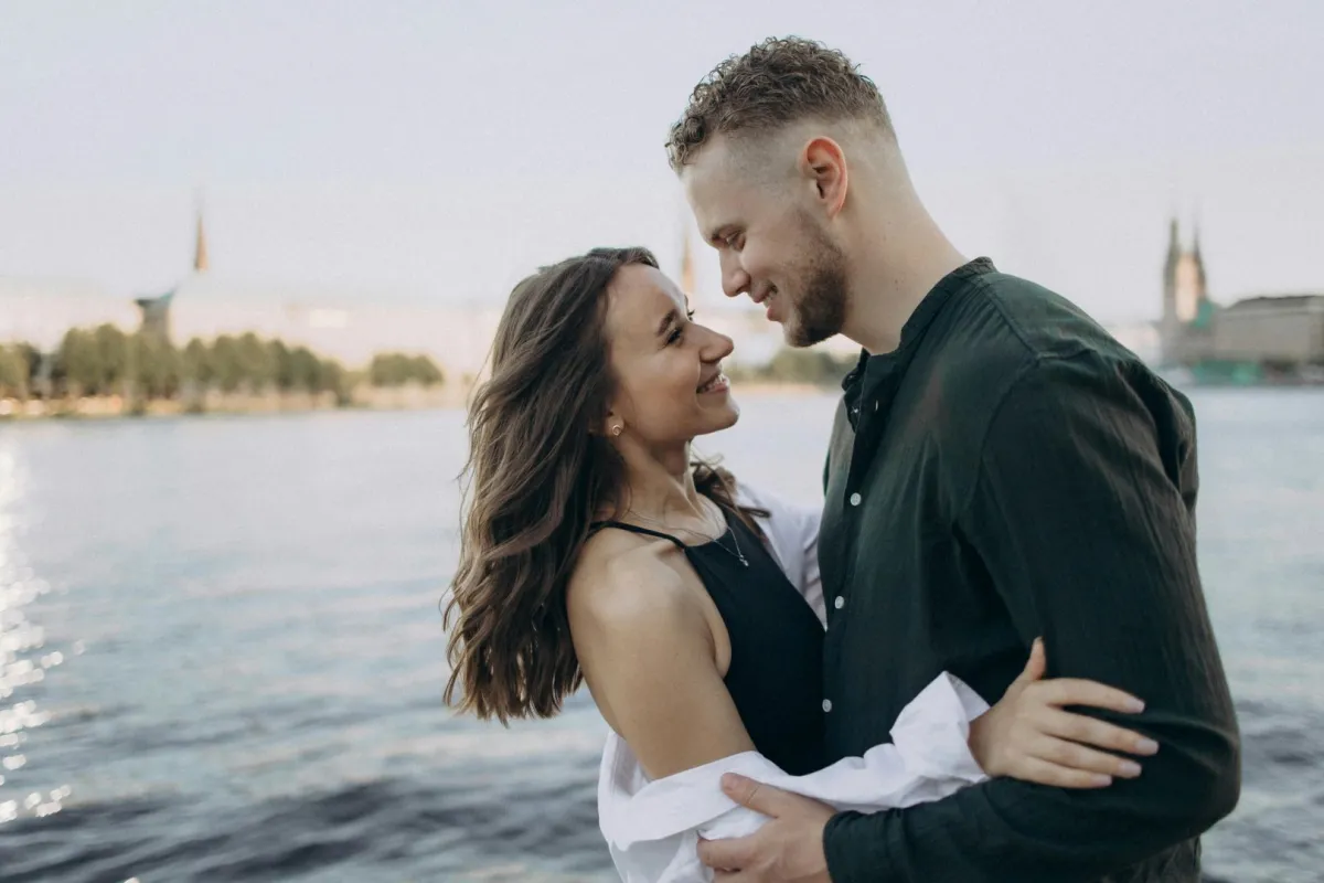 زوج يحتضن كتف زوجته ويمسك يدها وهي يبدو عليها الشعور بالسعادة والأمان