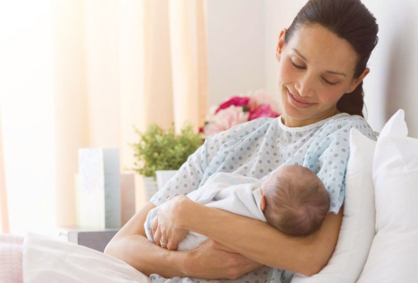 Postpartum mother relaxing at home in soft leakproof underwear