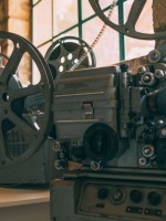جهاز عرض أفلام قديم في غرفة ريفية خافتة الإضاءة ذات جدران حجرية