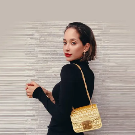 لانا الساحلي بحقيبة كتف ذهبية  