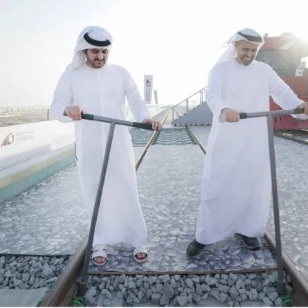 لحظة تثبيت القطعة الأخيرة على سكة القطار. الصورة من "وام"