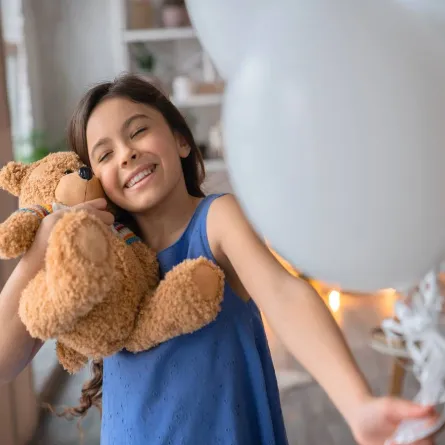 صورة لطفلة تلعب بالبالونات