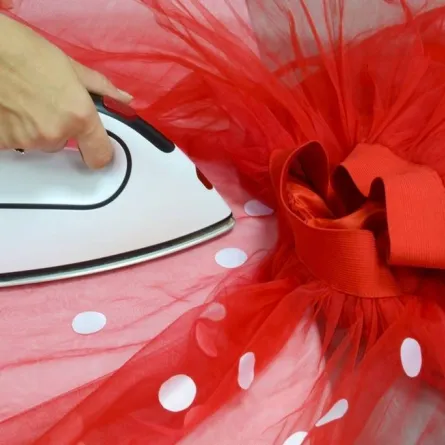 فستان أحمر مصنوع من التل ومحمّل بدوائر مصمّمة من الساتان