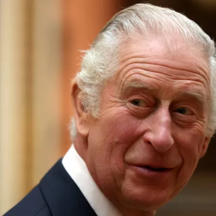 Britain's King Charles III reacts as he meets members of the Westend Gospel Choir after a ceremony commemorating the 50th anniversary of the Resettlement of British Asians from Uganda, at Buckingham Palace in London on November 2, 2022. ISABEL INFANTES / AFP / POOL