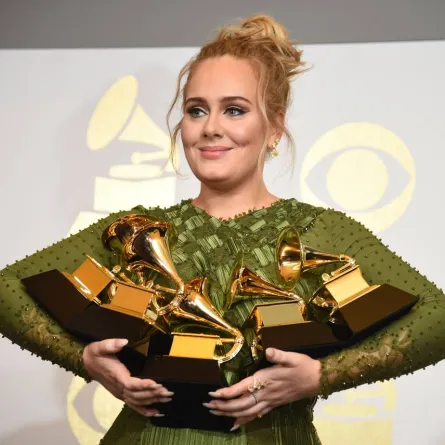 Adele poses in the press room with her trophies, including the top two Grammys of Album and Record of the Year for her blockbuster hit "Hello" and the album "25", during the 59th Annual Grammy music Awards on February 12, 2017, in Los Angeles, California. Robyn BECK / AFP