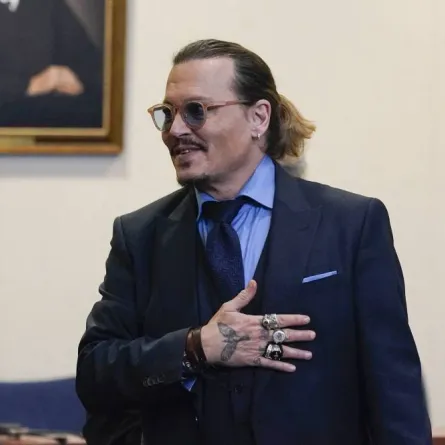 Actor Johnny Depp gestures to spectators in court after closing arguments at the Fairfax County Circuit Courthouse in Fairfax, Virginia, on May 27, 2022. Actor Johnny Depp is suing ex-wife Amber Heard for libel after she wrote an op-ed piece in The Washington Post in 2018 referring to herself as a “public figure representing domestic abuse.” Steve Helber / POOL / AFP
