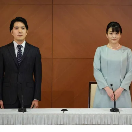 Japan's former princess Mako (R), the elder daughter of Prince Akishino and Princess Kiko, and her husband Kei Komuro (L), who she originally met while at university, pose at the start of a press conference to announce their marriage registration, at the Grand Arc Hotel in Tokyo on October 26, 2021. Nicolas Datiche / POOL / AFP