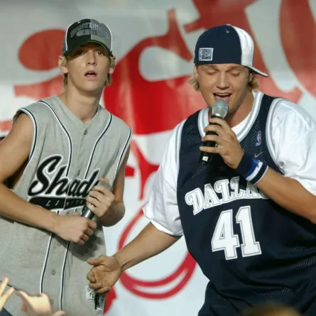 NEW YORK - SEPTEMBER 6: Backstreet Boy band member Nick Carter (R) joins his younger brother Aaron on stage for the final song in a concert sponsored by Hasbro at the South Street Seaport September 6, 2003 in New York City. (Photo by Stuart Ramson/Getty Images) Stuart Ramson / Getty Images North America / Getty Images via AFP