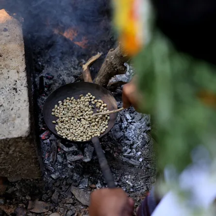 Saudi farmer Ahmed al-Malki, 42, roasts Khawlani coffee beans at a coffee farm in Saudi Arabia's southwestern region of Jizan on January 26, 2022. Jizan is known for its red Khawlani coffee beans, often blended with cardamom and saffron to give a yellowish hue of coffee -- locally known as ghawa. It remains an integral part of Saudi culture, so much so that the government has designated 2022 as "The Year of Saudi Coffee".  Fayez Nureldine / AFP