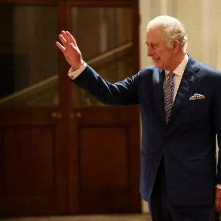 Britain's King Charles III waves as South Africa's President Cyril Ramaphosa (unseen) is driven away following a formal farewell at Buckingham Palace in London on November 23, 2022 at the end of the President's two-day state visit. Ramaphosa urged rich nations to help save vulnerable ones from climate change, as he made the first state visit of King Charles III's reign. HENRY NICHOLLS / POOL / AFP
