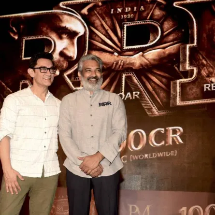 In this picture taken on April 6, 2022, Bollywood actor Aamir Khan (L) attends an event to celebrate the box office success of the Telugu-language period action drama film 'RRR' directed by S. S. Rajamouli (R) in Mumbai. SUJIT JAISWAL / AFP