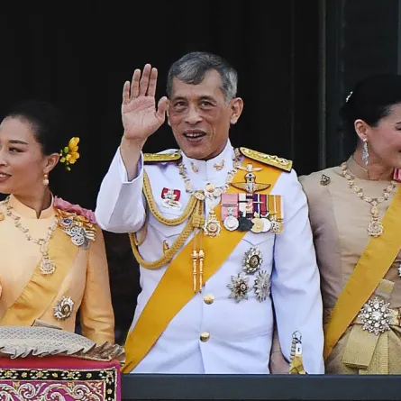 In this file photo taken on May 6, 2019, Thailand's King Maha Vajiralongkorn (C), Queen Suthida and his daughter Princess Bajrakitiyabha Mahidol (L) wave to well-wishers from the balcony of Suddhaisavarya Prasad Hall of the Grand Palace as they grant a public audience on the final day of his royal coronation in Bangkok.  Jewel SAMAD / AFP