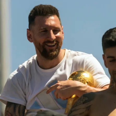 Argentina's Lionel Messi (L) holds the FIFA World Cup Trophy in Buenos Aires province, Argentina on December 20, 2022. TOMAS CUESTA / AFP