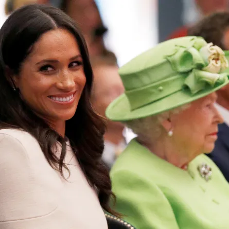 Britain's Queen Elizabeth II and Meghan, Duchess of Sussex gesture during their visit to the Storyhouse in Chester, Cheshire on June 14, 2018. PHIL NOBLE / POOL / AFP