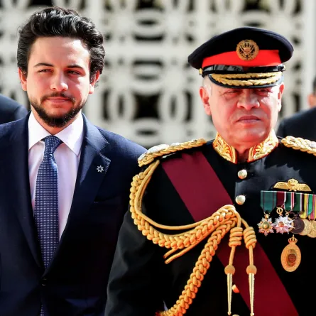 Jordan's King Abdullah II (R), accompanied by Crown Prince Hussein bin Abdullah II (L), reviews the honour guard upon his arrival at parliament, as he opens the regular session in the capital Amman on November 12, 2017. KHALIL MAZRAAWI / AFP