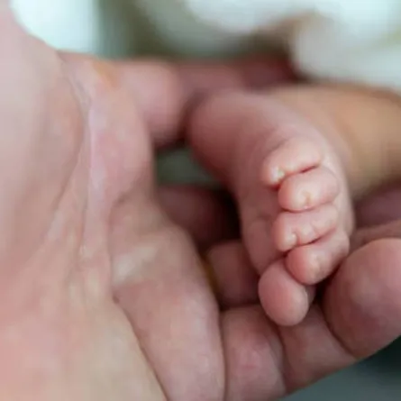 صورة لام تمسك بقدم رضيعها الصغيرة