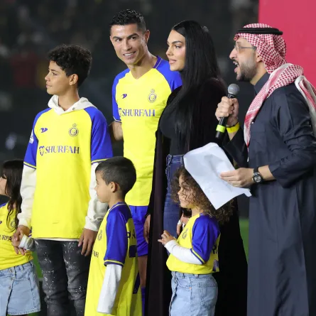 Al-Nassr's new Portuguese forward Cristiano Ronaldo (C-L), his partner Georgina Rodriguez (C-R) and his children stand on the stage during his unveiling at the Mrsool Park Stadium in the Saudi capital Riyadh on January 3, 2023. Fayez Nureldine / AFP
