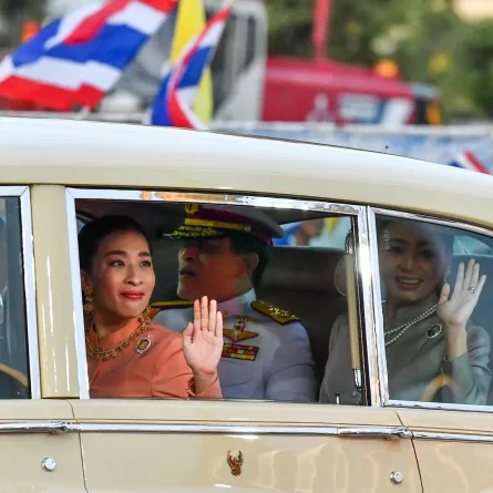 In this file photo taken on November 1, 2020 Thai Princess Bajrakitiyabha Mahidol (centre L) waves from a car, sitting next to Thailand's King Maha Vajiralongkorn (C) and Queen Suthida (R), on arrival at the Grand Palace in Bangkok. Lillian SUWANRUMPHA / AFP