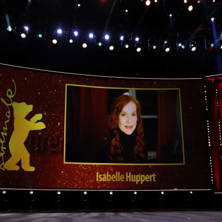 isabelle Huppert is seen on a screen as she takes part per video call in the Honorary Golden Bear ceremony prior the premiere of the film 'A propos de Joan (About Joan)' in the Berlinale Speciale Gala section of the 72nd Berlinale Film Festival in Berlin on February 15, 2022. Ronny HARTMANN / AFP