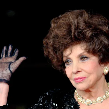 In this file photo taken on November 16, 2012, Italian actress Gina Lollobrigida waves upon her arrival for the premiere of the documentary film "Enzo Mirigliani" during the 7th Rome film festival. Tiziana FABI / AFP