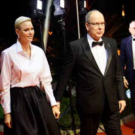Princess Charlene of Monaco and Prince Albert II of Monaco arrive on the red carpet before the 2022 World Rugby Awards ceremony in Monaco on November 20, 2022. CLEMENT MAHOUDEAU / AFP