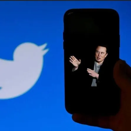 a photo of Elon Musk with the Twitter logo shown in the background, on October 4, 2022, in Washington, OLIVIER DOULIERY / AFP