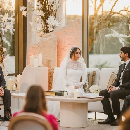  A handout picture released by Jordan's Royal Palace shows King Abdullah II (L) attending the wedding ceremony of his eldest daughter Princess Iman and Jameel Alexander Thermiotis (2nd R) in Amman on March 12, 2023. Thermiotis, who was born in 1994 in Venezuela to a family of Greek origin, currently works in the field of finance in New York. "AFP PHOTO / JORDANIAN ROYAL PALACE" -