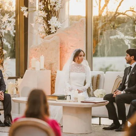 A handout picture released by Jordan's Royal Palace shows King Abdullah II (L) attending the wedding ceremony of his eldest daughter Princess Iman and Jameel Alexander Thermiotis (2nd R) in Amman on March 12, 2023. Thermiotis, who was born in 1994 in Venezuela to a family of Greek origin, currently works in the field of finance in New York. AFP PHOTO / JORDANIAN ROYAL PALACE