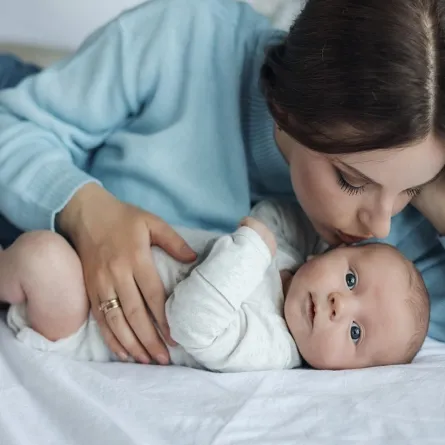 صورة لأم تقبل طفلها الرضيع