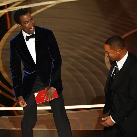  Will Smith (R) approaches US actor Chris Rock onstage during the 94th Oscars at the Dolby Theatre in Hollywood, California on March 27, 2022. Robyn Beck / AFP
