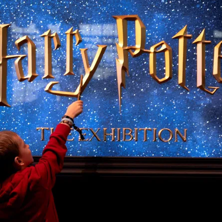 A young visitor holds a magic wand in Vienna, Austria on December 16, 2022. Andrea KLAMAR-HUTKOVA / AFP