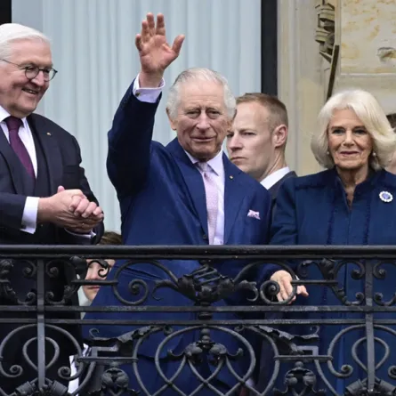 Britain's King Charles III (L) and Britain's Camilla (R), Queen Consort, greet wellwishers from the balcony of the city Hall, in Hamburg, northern Germany on March 31, 2023. Britain's Royal Couple is on a three-day tour in Germany for Charles' first state visit as king, with the trip billed as "an important European gesture" to maintain strong ties after Brexit. John MACDOUGALL / AFP