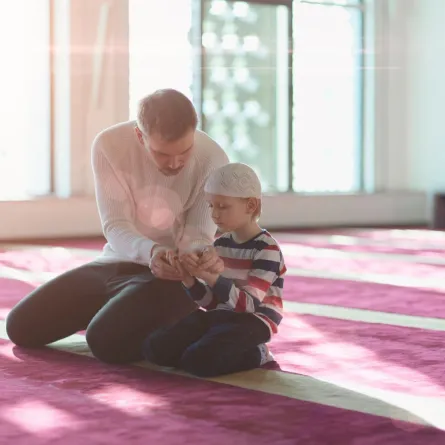 صورة لصلاة الطفل مع والده
