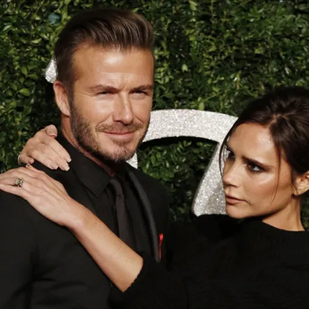 David Beckham and his wife British fashion designer and singer Victoria pose for pictures on the red carpet upon arrival to attend the British Fashion Awards 2014 in London on December 1, 2014. AFP PHOTO/JUSTIN TALLIS