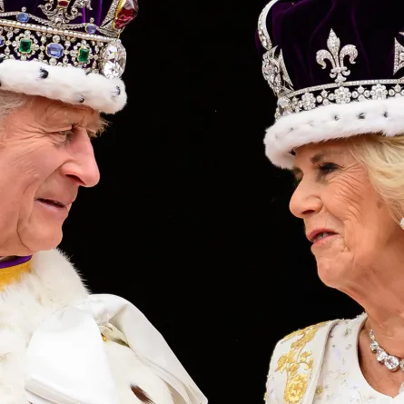 King Charles III (L) looks at Queen Camilla as they stand on the Buckingham Palace balcony, in London, following their coronations, on May 6, 2023.  Leon Neal / POOL / AFP