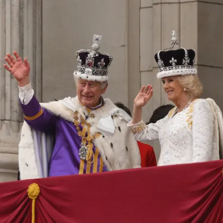 King Charles III and Queen Camilla wave from the Buckingham Palace balcony in central London on May 6, 2023. (Photo by Daniel LEAL / AFP)