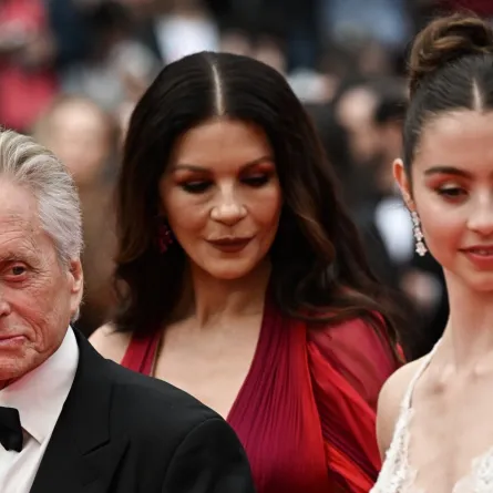 Michael Douglas arrives with his wife British actress Catherine Zeta-Jones (C) and daughter Carys for the opening ceremony and the screening of the film "Jeanne du Barry" during the 76th edition of the Cannes Film Festival in Cannes, southern France, on May 16, 2023. (Photo by LOIC VENANCE / AFP)